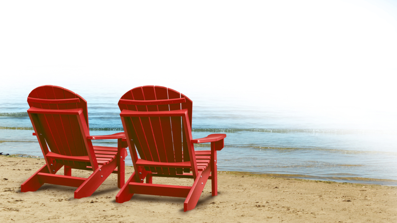 Two Adirondack chairs by the sea