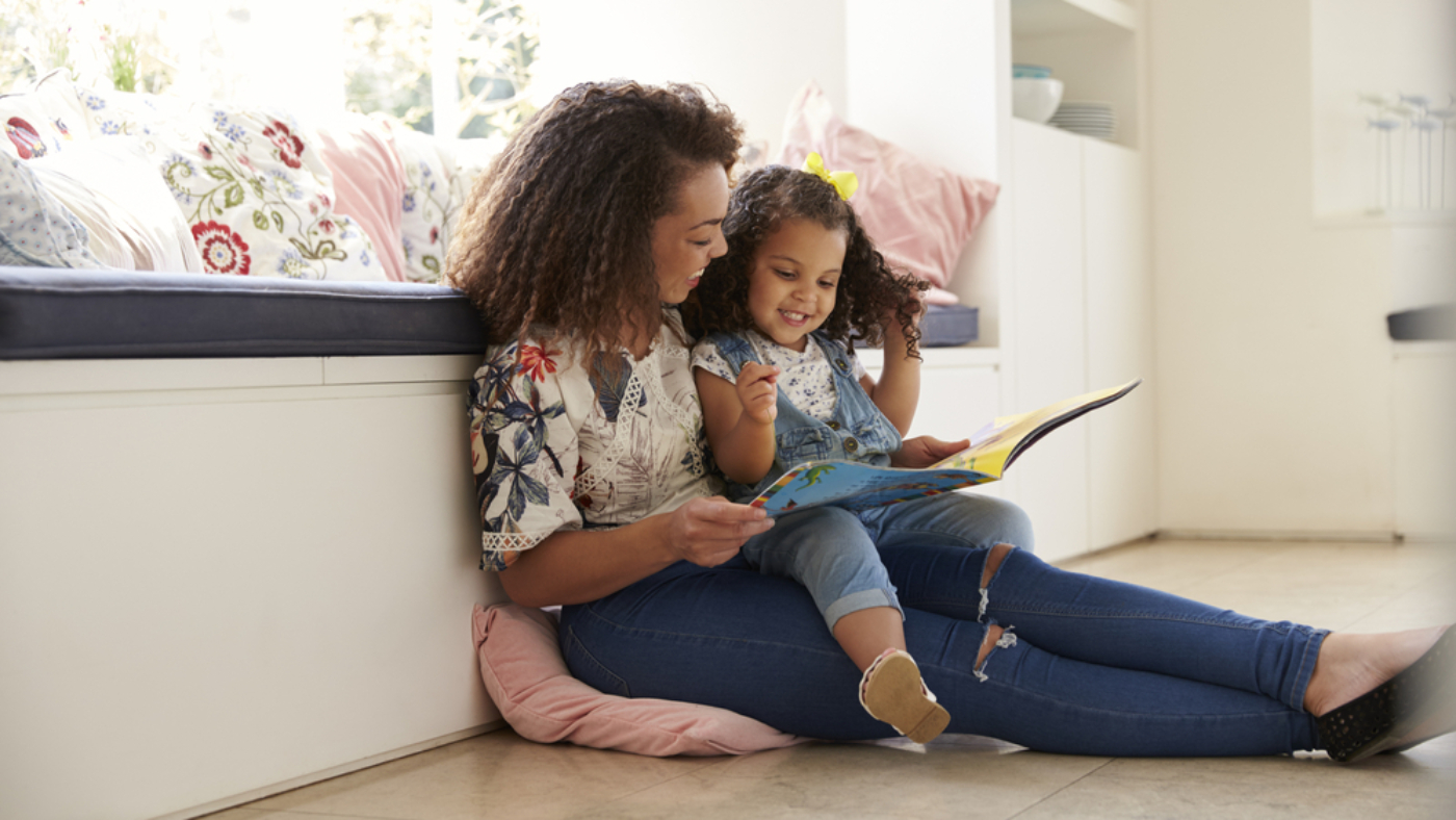 Mother reading a book with her daughter